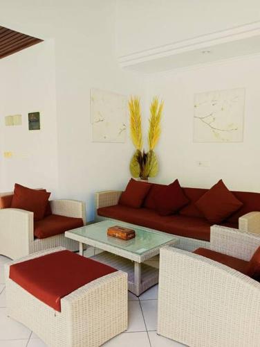 a living room with a couch and a table at BrightUp Villa Beach Side Sanur in Sanur