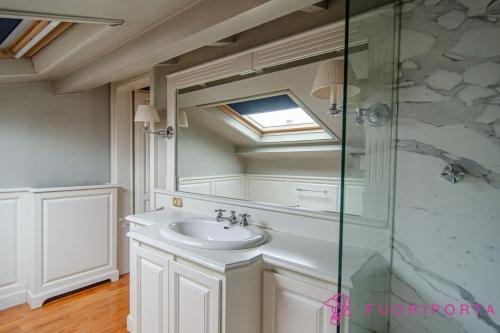 a bathroom with a sink and a mirror at Le Belle Époque in Parma