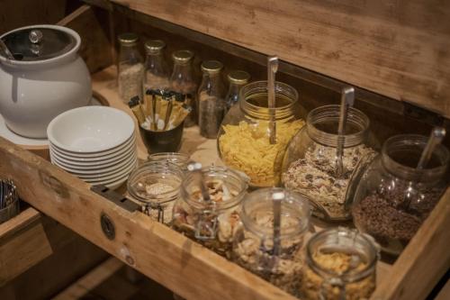 a wooden shelf with jars of food and other items at Pension Moarhof in Feldthurns