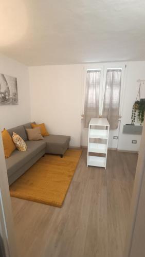 a living room with a couch and a white ladder at Fiori di Loto Home in Iesi