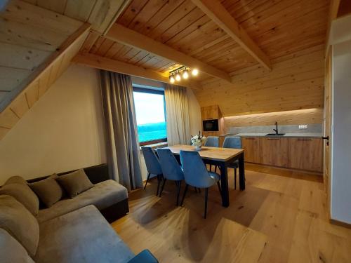 a living room with a couch and a table at Willa Maciejka in Trybsz