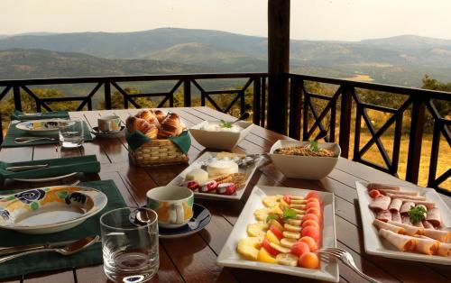 a table with plates of food on top of a balcony at Pakamisa Private Game Reserve in Pongola