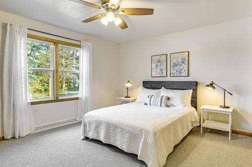 a white bedroom with a bed and a ceiling fan at Lakefront Wisconsin Getaway Fish, Boat, Relax! in Birnamwood
