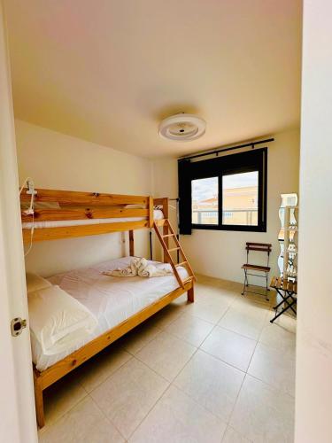 a bedroom with two bunk beds and a window at Attic terrace 360 Moncofa in Moncófar