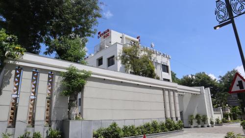 a white building with plants on the side at The Legend Inn @Nagpur in Nagpur