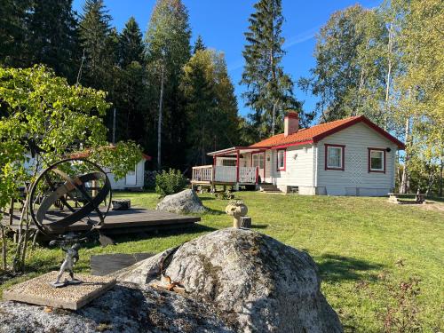 a statue of a waterwheel in front of a house at Husby in Färjan
