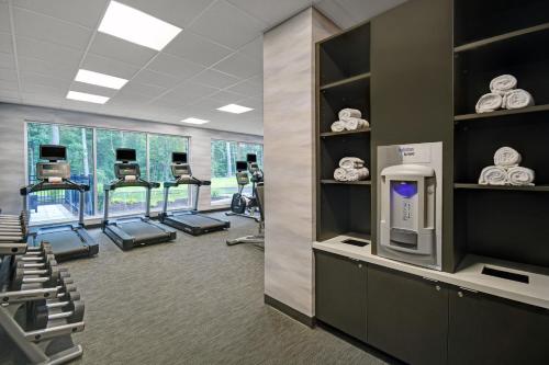 a gym with a row of treadmills and machines at Fairfield by Marriott Inn & Suites Mansfield in Mansfield