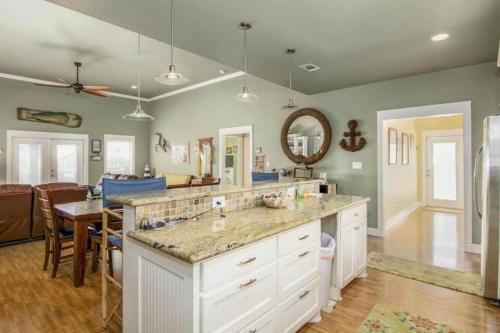 a kitchen with a large counter and a dining room at JUST LISTED Beach House Steps Away from the Beach in Bolivar Peninsula