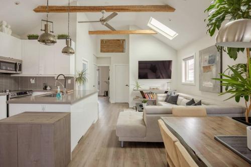a kitchen and living room with a couch and a table at Lonborough Ave Upstairs in Toronto