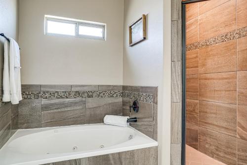 a bathroom with a bath tub and a window at El Paso Home Near Downtown and Parks in El Paso