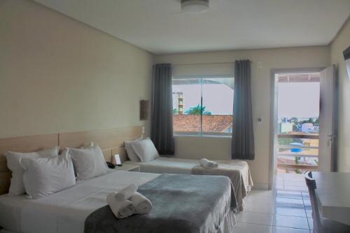 Ένα ή περισσότερα κρεβάτια σε δωμάτιο στο Hotel Brisa da Costa