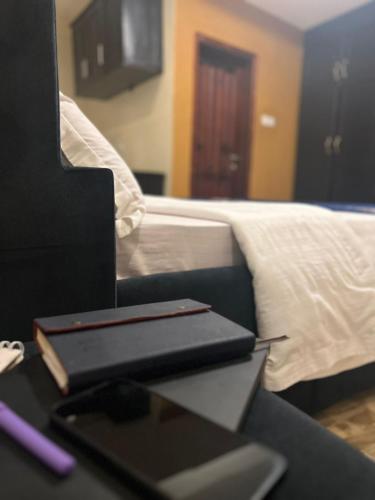 a laptop computer sitting on a desk next to a bed at Royal Hotel Apartments in Kampala