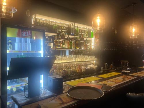 a bar with a lot of bottles of alcohol at Royal Hotel Apartments in Kampala