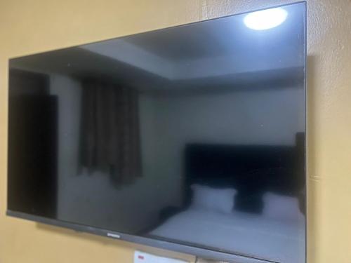 a mirror hanging on a wall in a room at Royal Hotel Apartments in Kampala