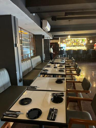 a long row of tables in a restaurant at Royal Hotel Apartments in Kampala