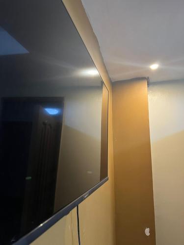 a mirror on a wall in a room at Royal Hotel Apartments in Kampala