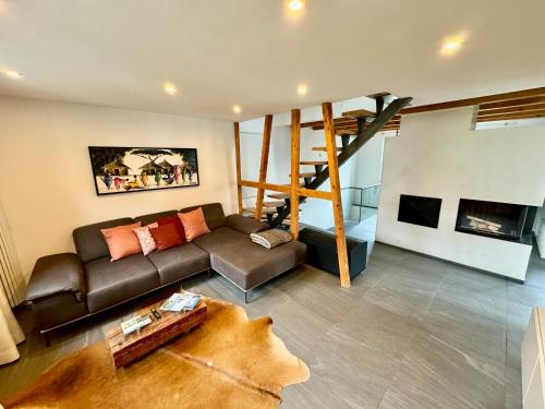 a living room with a couch and a staircase at Gemütliches Häuschen im Ortskern von Hohentengen am Hochrhein in Hohentengen