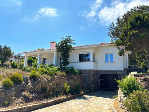 a large white house with a driveway at Villa Haass in Stintino