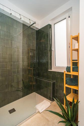 a shower with a glass door in a bathroom at H H Moneglia il Vicolo in Moneglia