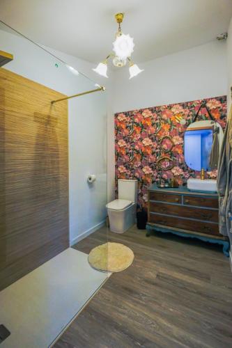 a bathroom with a large painting on the wall at Villa de Loarre in Loarre