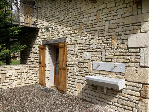 a stone building with a sink on the side of it at POD Nature 2 in Chazelles