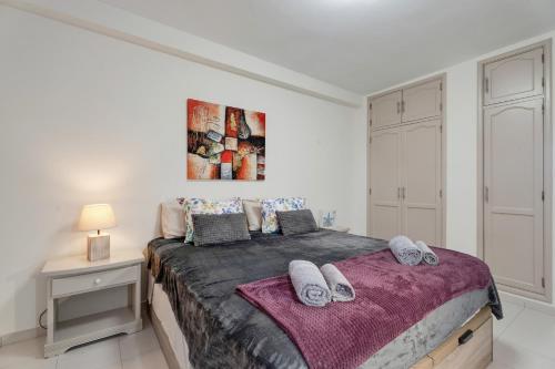 a bedroom with a large bed with towels on it at Seaview las Americas in Adeje