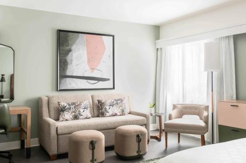 a living room with a couch and a chair at Hotel Indigo Saint Louis Central West End by IHG in Saint Louis