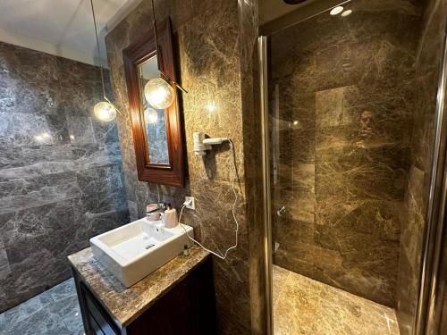 a bathroom with a sink and a shower at huzurlu ve şirin in Istanbul