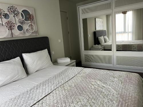 a bedroom with a bed and a large mirror at huzurlu ve şirin in Istanbul