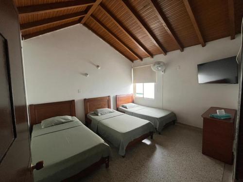 Postel nebo postele na pokoji v ubytování Hotel el Recuerdo