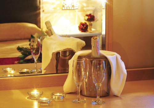 a table with two glasses and a bottle of wine at Iris Hotel in Thérmi