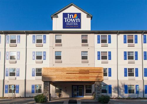 a large white building with a sign on top at InTown Suites Extended Stay Newport News VA - City Center in Newport News