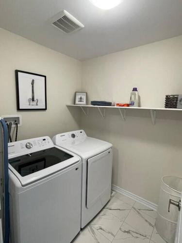 a white laundry room with a washer and dryer at Cozy 3-Bedrooms T-Home #Niagara in Thorold