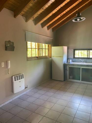 a room with a kitchen with a sink and a heater at Departamento en Guaymallén in Guaymallen