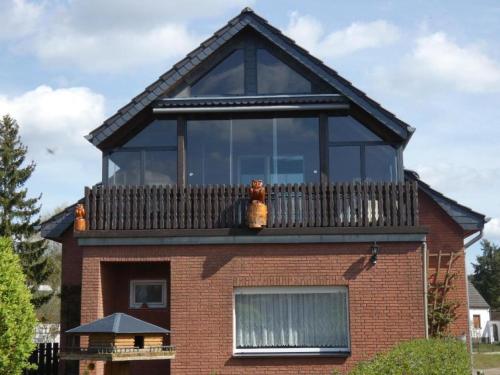 a house with a balcony on top of it at Radlerzimmer (Zweibettzimmer) in Strasen