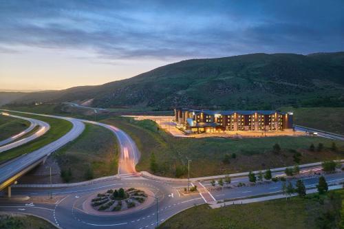 a building on a hill next to a highway at SpringHill Suites by Marriott Avon Vail Valley in Avon