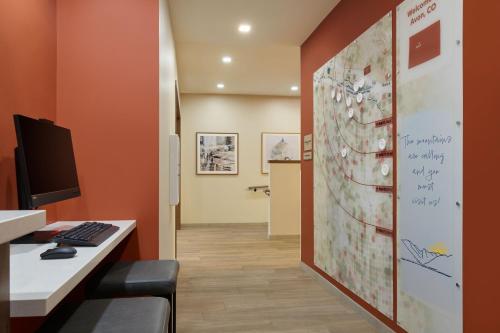 an office with a desk and a computer on a wall at SpringHill Suites by Marriott Avon Vail Valley in Avon