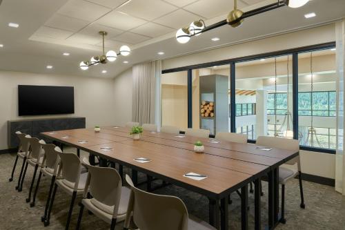 a conference room with a large wooden table and chairs at SpringHill Suites by Marriott Avon Vail Valley in Avon