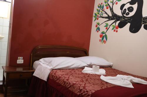 Ένα ή περισσότερα κρεβάτια σε δωμάτιο στο Andes Hostal