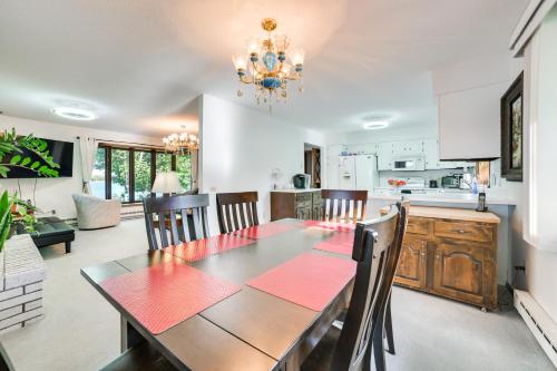 a dining room and kitchen with a table and chairs at Riverfront Sault Ste Marie Home with Dock! in Sault Ste. Marie