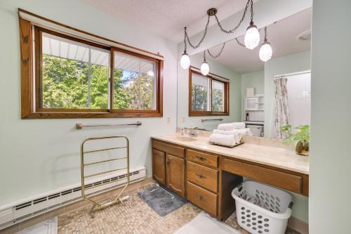 a bathroom with a sink and a mirror at Riverfront Sault Ste Marie Home with Dock! in Sault Ste. Marie