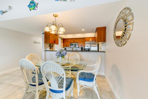 a dining room with a table and chairs and a kitchen at Oceanfront Redington Shores Retreat Beach Access! in Clearwater Beach