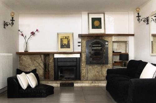 a living room with a fireplace and a couch at LOFT SUL FIUME center home in Ascoli Piceno