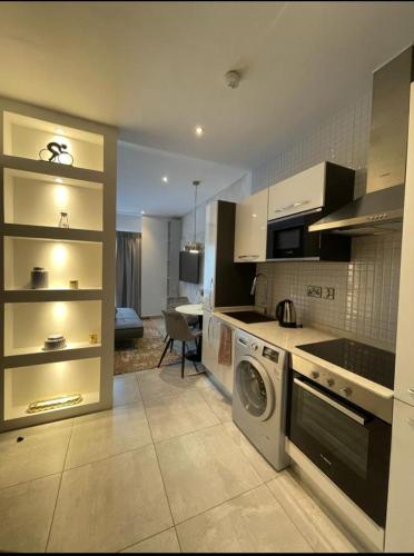 a kitchen with a washer and dryer in it at The Signature Hotel Apartment Accra Ghana in Accra