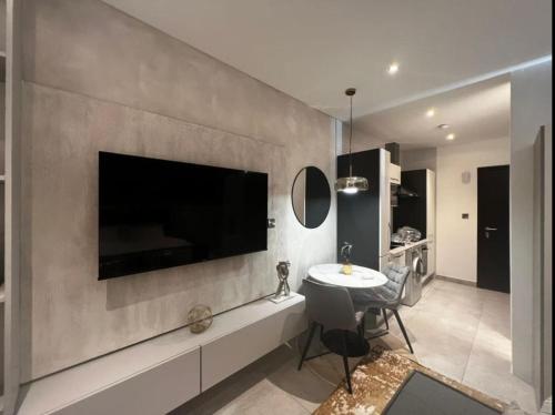 a living room with a large television on a wall at The Signature Hotel Apartment Accra Ghana in Accra