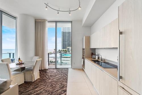 a kitchen and dining room with a view of the ocean at Discover the Magic of Lyfe Resort and Residences in Hollywood