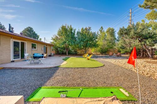a yard with a green lawn and a flag at Central Boulder Home with Outdoor Oasis, Walk to CU! in Boulder