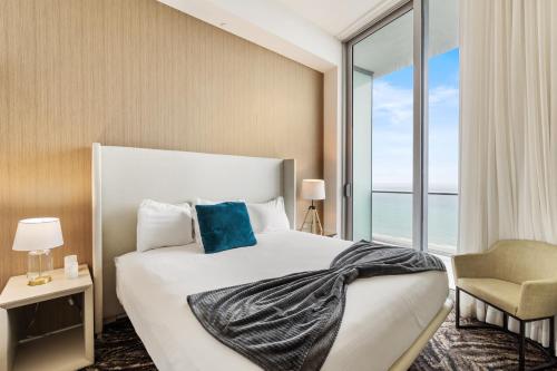 a bedroom with a bed and a large window at Discover the Magic of Lyfe Resort and Residences in Hollywood