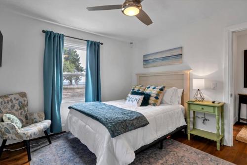 a bedroom with a bed and a chair and a window at Retro by the Bay Close to Beach Eglin PetFriendly in Freeport