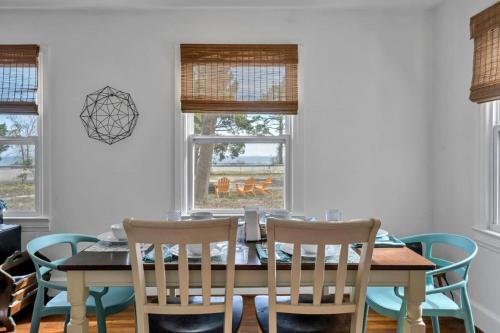 a dining room with a table and chairs and windows at Retro by the Bay Close to Beach Eglin PetFriendly in Freeport